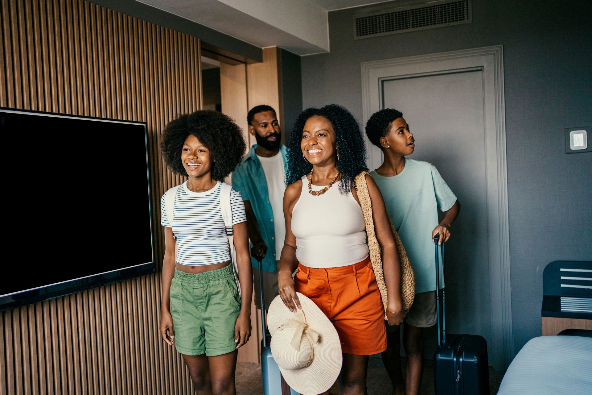 Family arriving at hotel bedroom